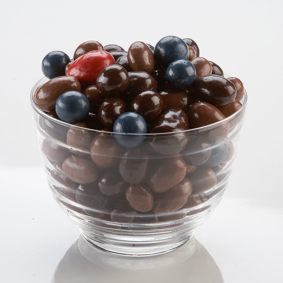 chocolate covered peanuts, raisins, almonds, cashews, blueberries and cherries in a bowl